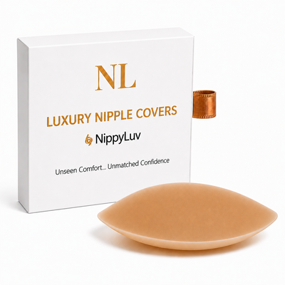 A NippyLuv 'Luxury Nipple Covers' in a caramel shade, shown in front of its white packaging box with gold lettering.