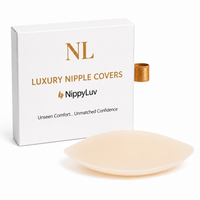 An Ivory silicone nipple cover shown in front of its white packaging box with gold lettering. The box features the brand names 'NLP' and 'NippyLuv' and reads 'Luxury Nipple Covers'.